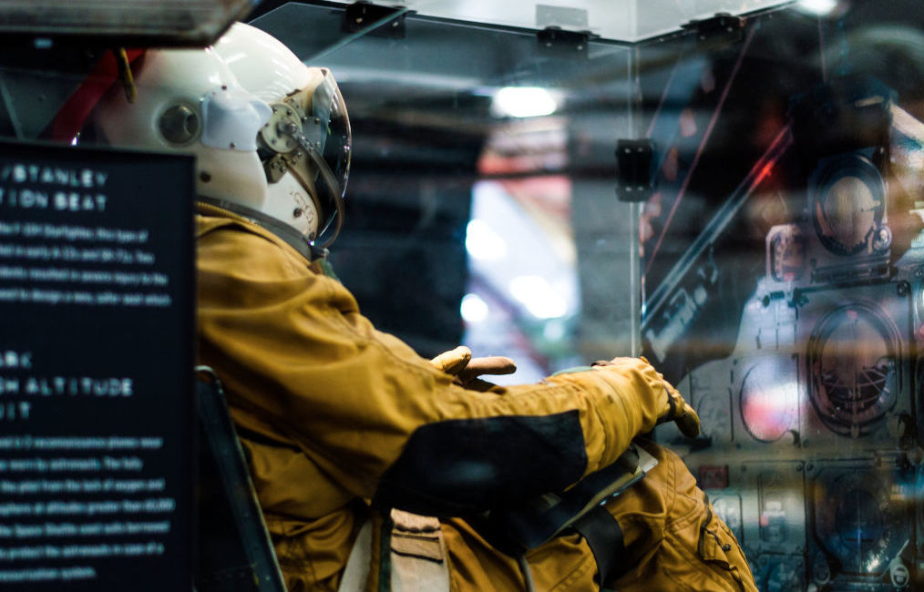 Astronaut in a chair watching panels